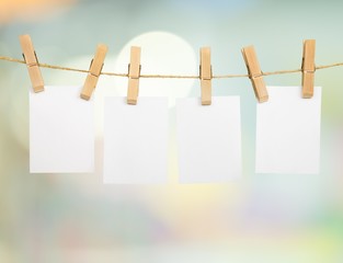 Hanging empty white card on a rod with abstract background