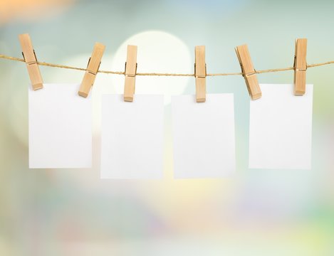 Hanging empty white card on a rod with abstract background
