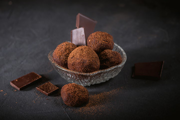 Small chocolate potato cake on dark background