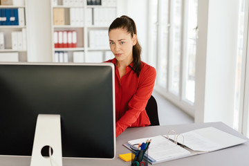 Serious sceptical young businesswoman