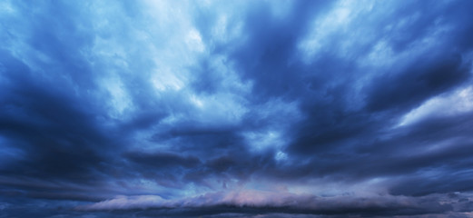 Naklejka na ściany i meble Ominous storm cloudscape at sunset