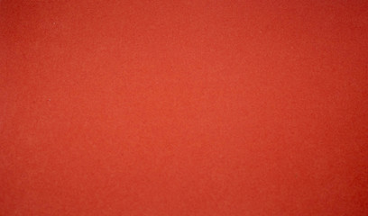 Background from a red perfect suede fabric. Velvet texture