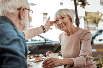 Nice aged man touching his wifes hair