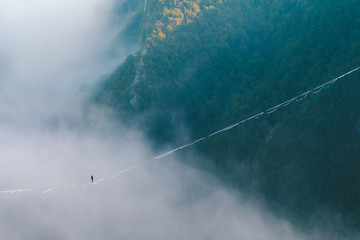 Highliner goes on a sling above the clouds.