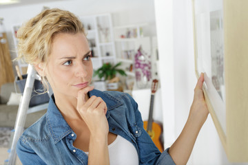 a woman looking at a frame