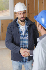 portrait of contractors shaking hands