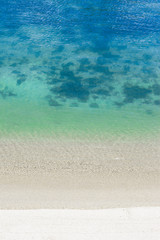 Soft wave of blue ocean on sandy beach. Background.