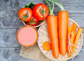 Glass of carrot juice and fresh carrots, tomato isolated on wood background. drinking for healthy 