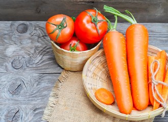 Top view fresh carrots and tomato isolated on wood background. drinking for healthy 