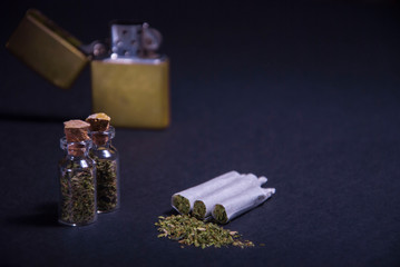 medicinal marijuana with medical use. Flatlay cigarettes with grass, a lighter, a phonendoscope, a bottle for drugs