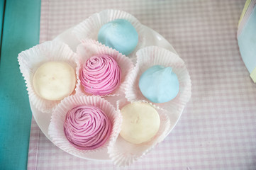 Children's wooden and textile toys. Toy trolley with ice cream and cupcakes. Handmade textile ice cream close-up and copy space. Brownies on a wooden trolley