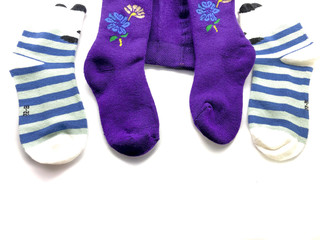 Set of socks isolated on a white background. Composition of multi-colored socks. Children's socks. Socks background.