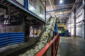 Fototapeta na wymiar moving conveyor transporter on Modern waste recycling processing plant. Separate and sorting garbage collection. Recycling and storage of waste for further disposal.