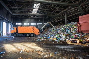 truck throws garbage at sorting modern waste recycling processing plant. Separate and sorting...