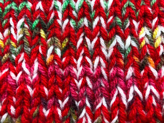 Knitted background. Background of red knitwear close-up.