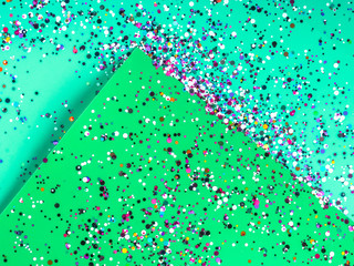 Paper sheets in mixed green colors with holographic foil confetti. Trendy mint and green abstract...