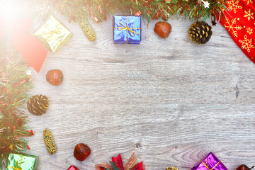 Top view Christmas background with decorations and gift boxes on wooden board. Soft select focus. copy space