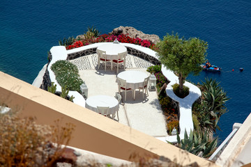 The restaurant tables under the open sky, Oia town