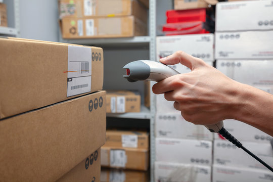 Warehouse worker scans the bar code of a product
