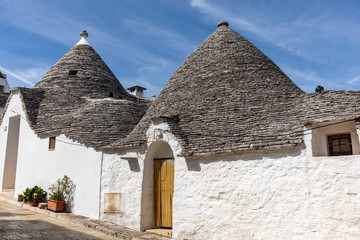 Fototapeta na wymiar Trulli village in Alberobello, Italy. The style of construction is specific to the Murge area of the Italian region of Apulia (in Italian Puglia). Made of limestone and keystone.