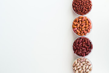Different seed beans in round plates are arranged in a row.