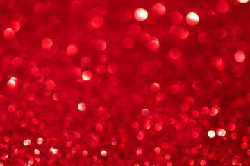 Red defocused glitter backround.