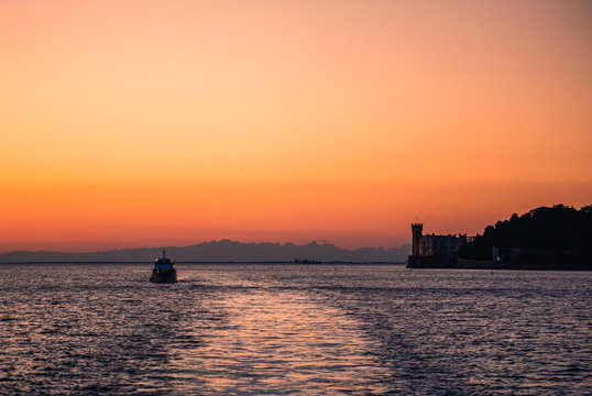 Dramatic view of the tourist spot Castello di Miamare (Castle of Miramare) in Trieste, Italy on the Mediterranean sea coast in europe while sunset. © Moritz Klingenstein