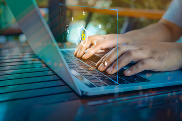 Businessman using a laptop computer with technology cybersecurity and privacy concept. protection and safe data for global network security.