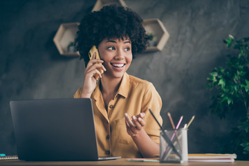 Photo of cheerful positive mixed-race pretty woman working as content manager arranging with her...