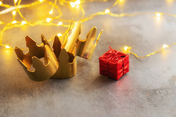 Three gold crowns and red gift box for concept of Epiphany or Dia de Reyes Magos ,  where in Spain...