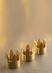 Three gold crowns on black background, symbol of Tres Reyes Magos  ( Three Wise Men) who come...