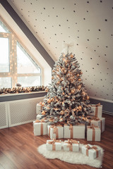 Christmas Tree in the Interior. Christmas decor. The interior is decorated with pine and decorative light