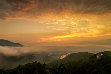 Fototapeta na wymiar Mountain view misty morning above Kok river and Tha Ton city in valley around with sea of mist with cloudy sky background, sunrise at Wat Tha Ton, Fang, Chiang Mai, northern of Thailand.