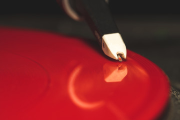 Detail view of a needle reading a vinyl record