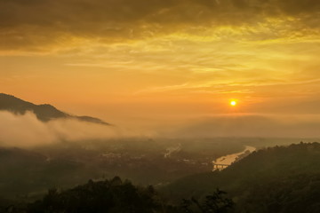 Mountain view misty morning above Kok river and Tha Ton city in valley around with sea of mist with cloudy sky background, sunrise at Wat Tha Ton, Fang, Chiang Mai, northern of Thailand.