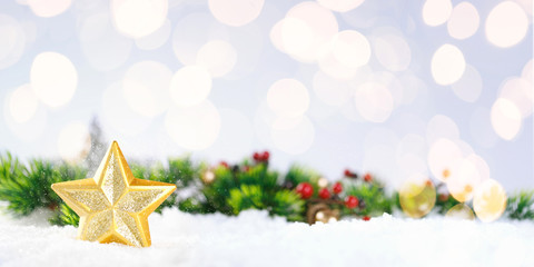 Christmas gold star on snow with decoration