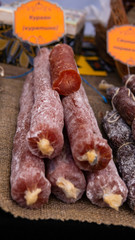 Closeup of a variety of cooked meats, salamis and sausages at a delicatessen