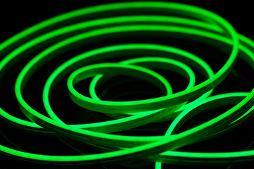Green flexible led tape neon flex on black background.