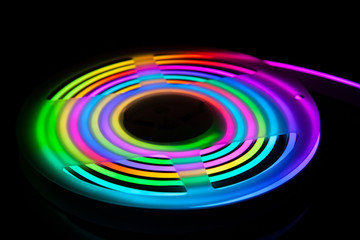 Flexible RGB led tape neon flex in different colors on black background.