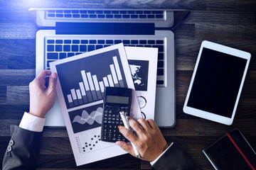 Top view business hand working with laptop computer, tablet and smart phone in office with digital marketing media  in virtual icon