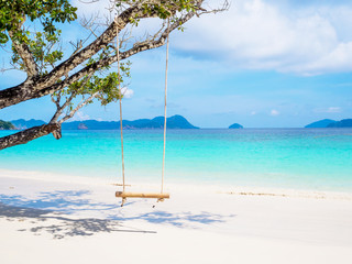 Rope and bamboo swing with white sand beach sea view background, Travel plans in holidays or after retirement