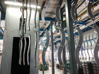 Powder coating line. Industrial interior. Workshop equipped with conveyors.