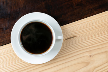 Cup of americano coffee on Dark and light wooden table.: copy space
