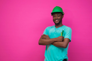 a young african engineer feels happy about his profession and  holds a screwdriver