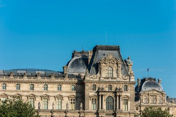 Fototapeta premium The rooftop of Louvre Museum at the right bank of Seine Rive, the world's largest art museum and a historic monument in Paris, France. A central landmark of the Paris city.