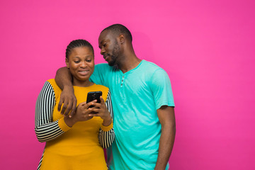 young african lady feeling happy with what she saw on her guy phone