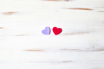 Two hearts on a white wooden background.