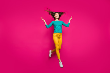 Fototapeta na wymiar Full length body size photo of cheerful positive running girlfriend jumping throwing her hair up smiling toothily in teal shirt isolated fuchsia vivid color background