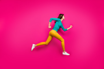 Fototapeta na wymiar Full length body size photo of pretty cute nice sweet girl running towards shopping senter in footwear yellow pants isolated vivid color pink background