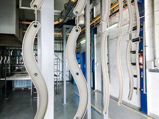 Powder coating line. Industrial interior. Workshop equipped with conveyors.